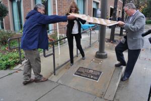 Pasadena Mayor Terry Tornek, LA Financial Credit Union VP Amanda O'Brien and Pasadena Chamber CEO Paul Little unveil the plaque.
